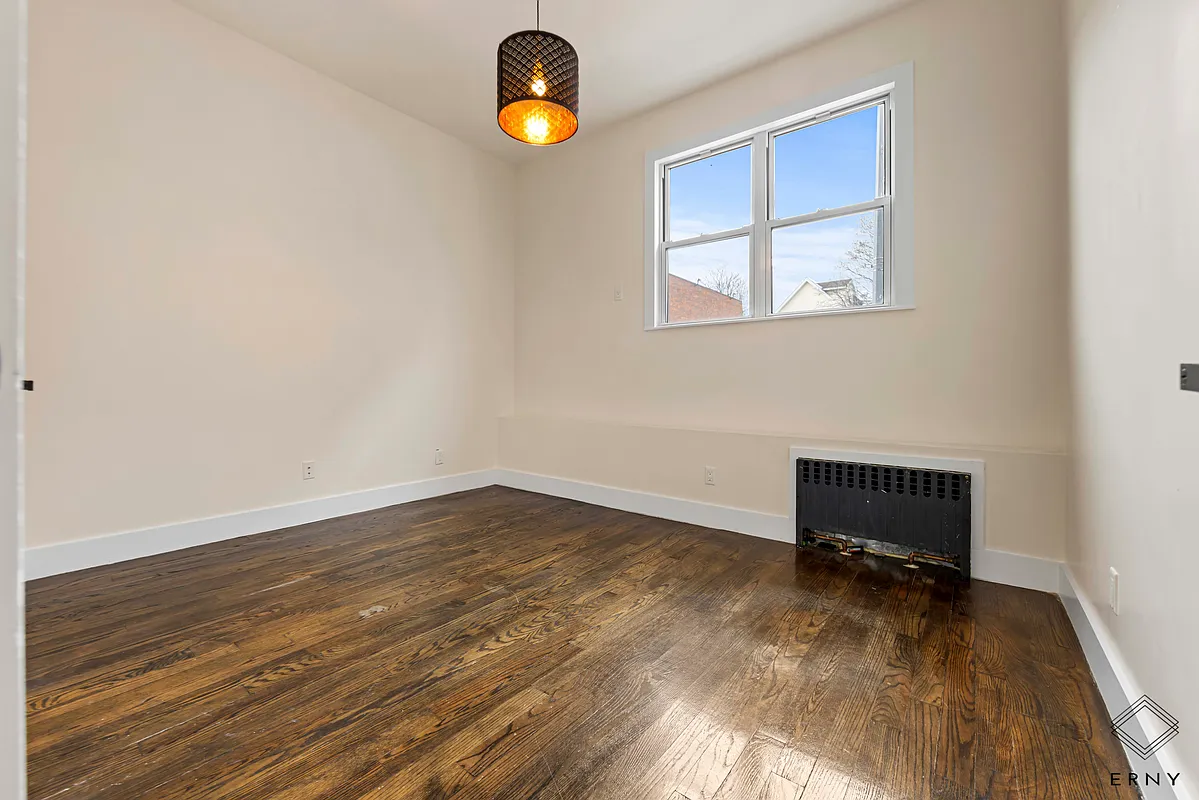 Finished bedroom with hardwood flooring at 200 Lawrence Avenue Apartment 1