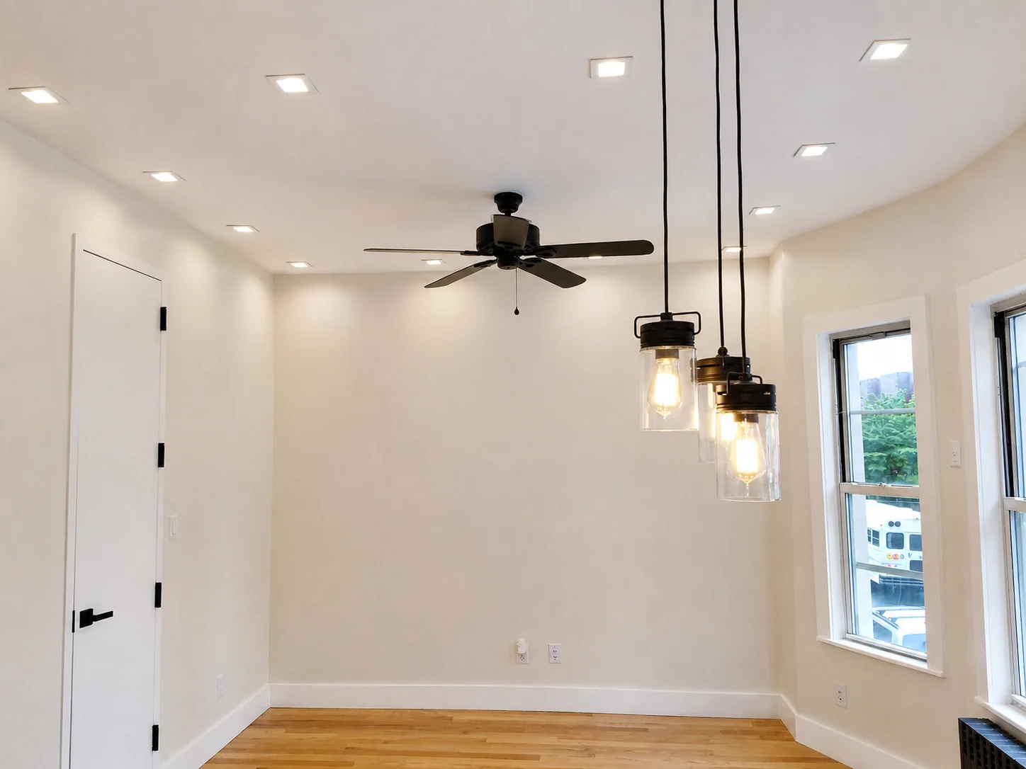 Completed painted room with crisp white trim, windows and warm interior lighting